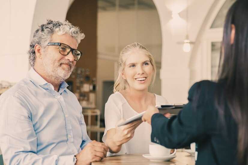 happy-young-mature-customers-meeting-with-agent-giving-signed-insurance-agreement-her_74855-15165