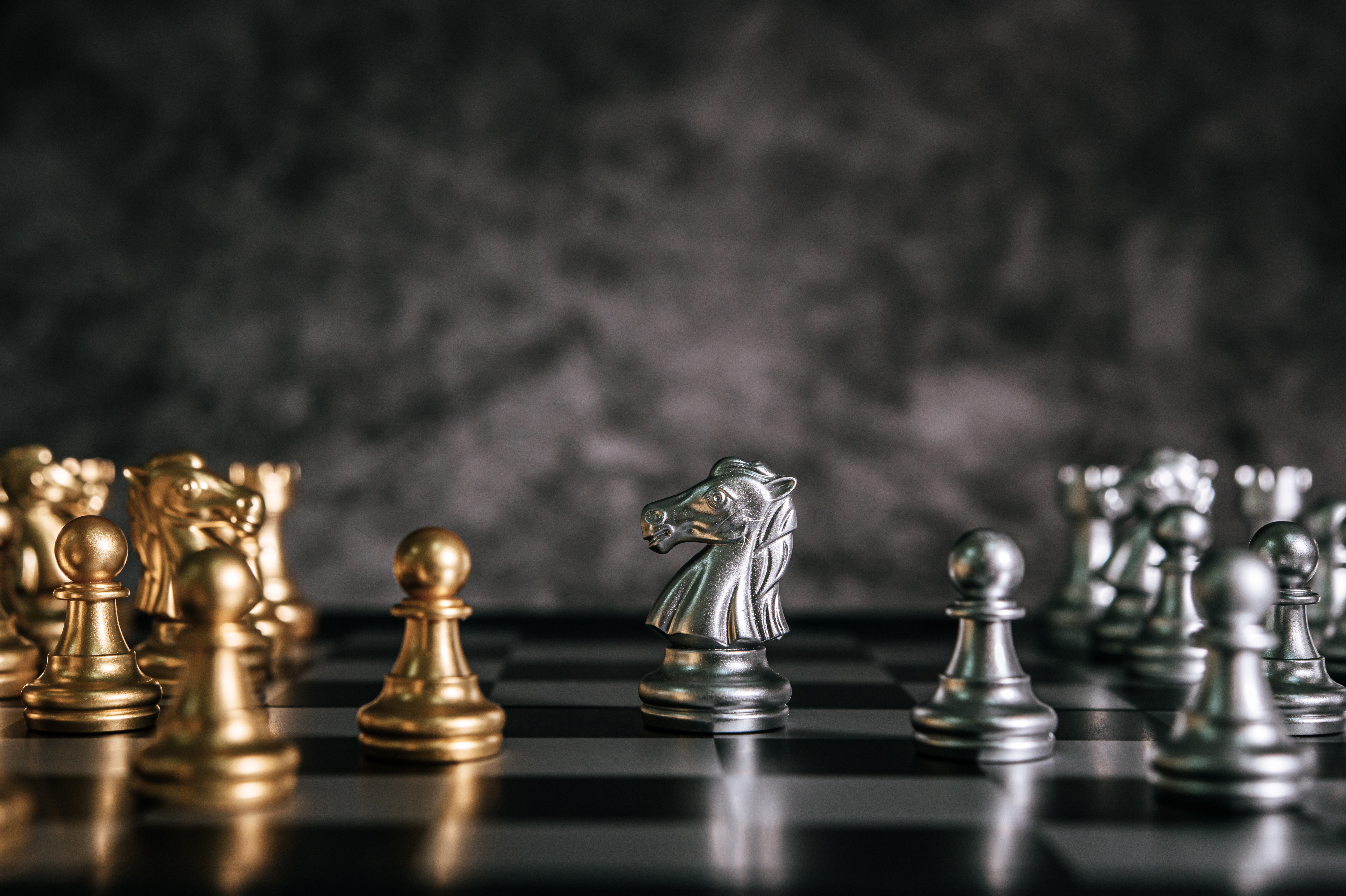 Gold and Silver Chess on chess board game for business metaphor שחמט